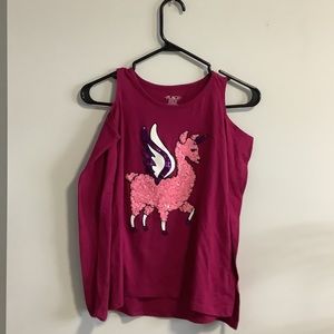 Off the shoulder pink unicorn patterned shirt.